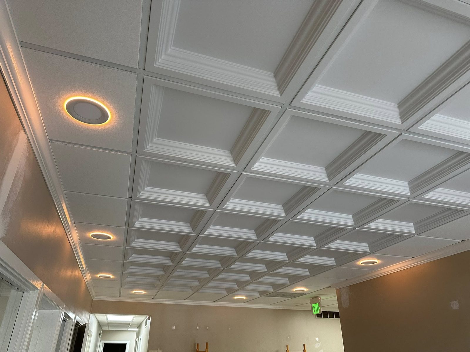Detail of decorative coffered ceiling tiles with recessed lighting