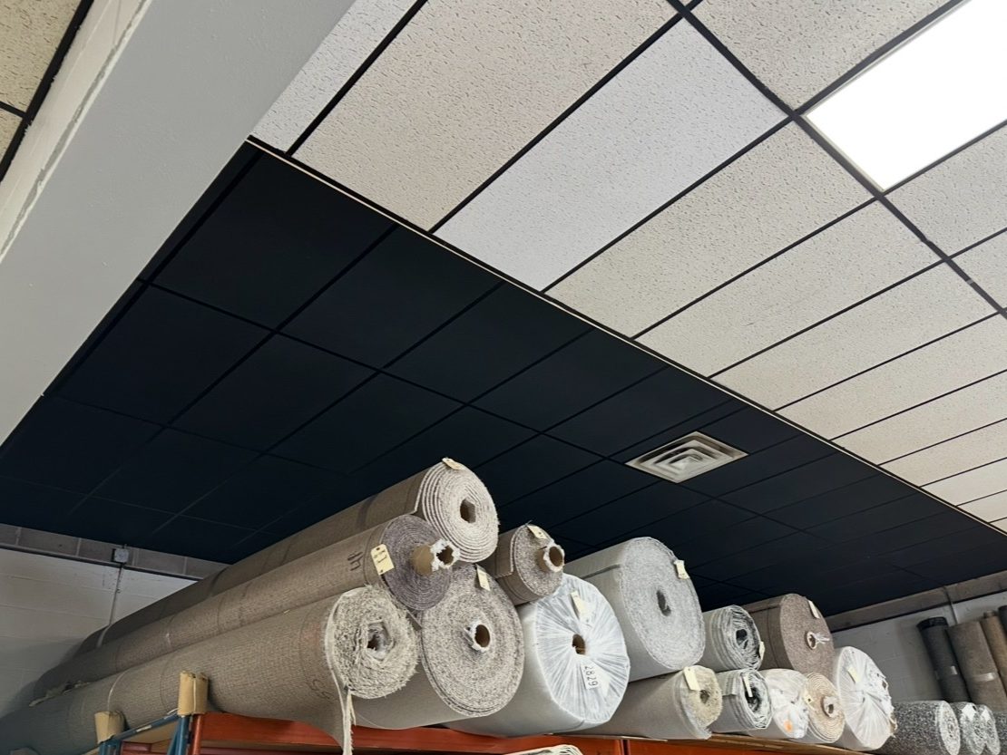 Carpet showroom ceiling with two-tone black and white tiles