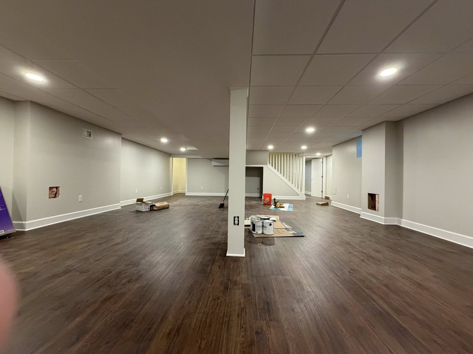 Large finished basement with light grey suspended ceiling
